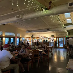 people sitting at tables in a restaurant