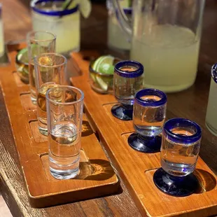 shot glasses and pitchers on a table