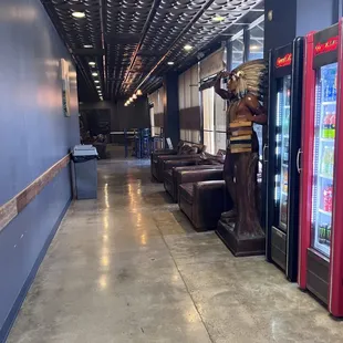 Entrance of store with hallway leading to bar and seating area on the right of the lounge.