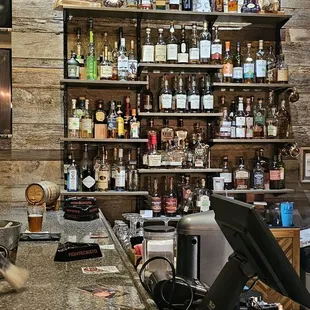 a bar with liquor bottles on shelves