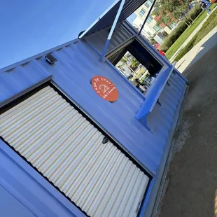 a blue building with a sign on it