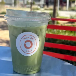 a cup of green tea on a table