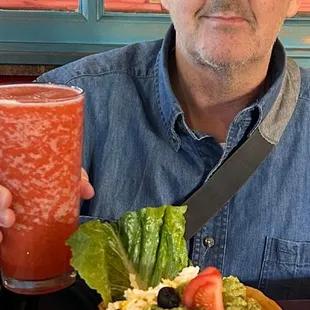 BRYAN, raising a glass with his Non-Alcoholic Margarita, and his Concha de Guacamole.