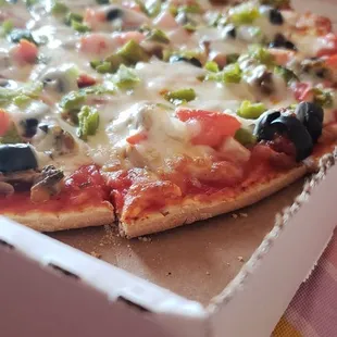 Card board like crust,  and lack of meat for it being a supreme pizza