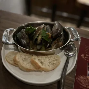 a bowl of mussels and bread