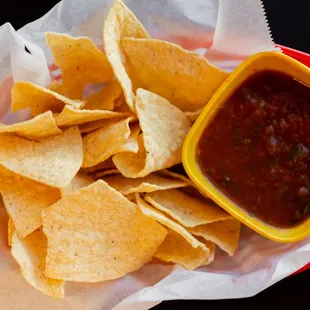 a bowl of salsa and chips