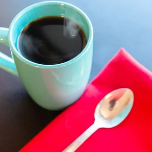 a cup of coffee and a spoon