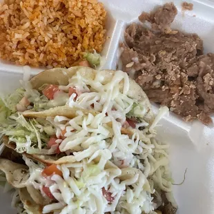 The shredded beef tacos are amazing but sadly paired with dry rice and overcooked beans.