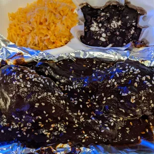 Chicken mole with rice and black beans.