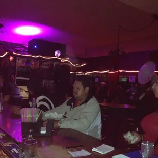 a group of people sitting at a bar