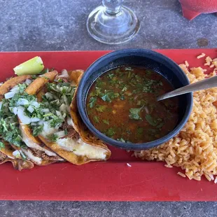 Birria taco and consumé with mexican rice