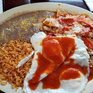 Spicy chilaquiles plate,  over easy eggs. I added extra salsa on top