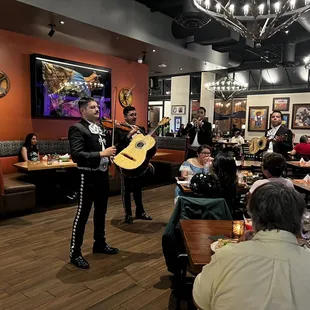 a mexican band playing in a restaurant