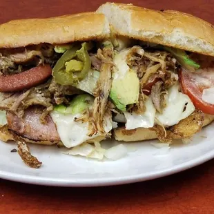 a sandwich with meat, lettuce, and tomato