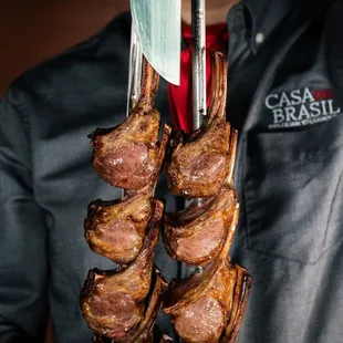 a man holding a rack of meat