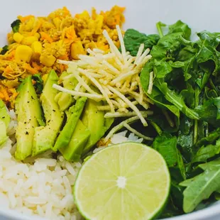 Bossa Nova Bowl with Brazilian Chicken Salad, fresh greens, rice, topped with avocado and cilantro cream sauce.
