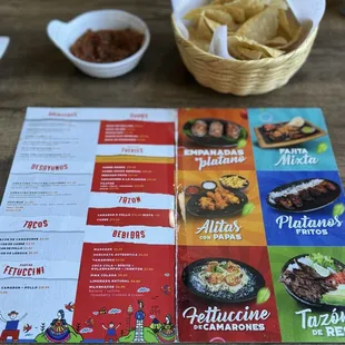 Menu and some chips with salsa.