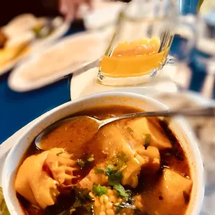 a bowl of soup with a spoon in it