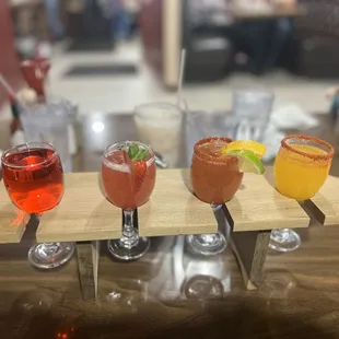 a variety of drinks on a wooden tray