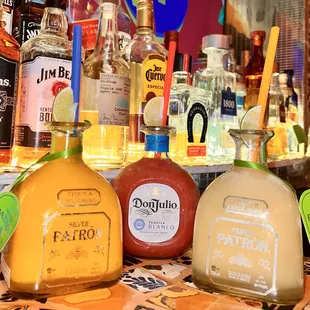 a variety of tequila bottles on a bar