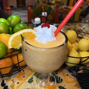 a smoothie with a straw and a cherry