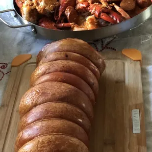 a pan of seafood and a croissant