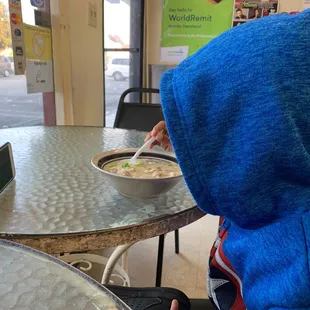 a child eating a bowl of food