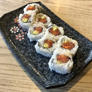 sushi rolls on a black plate