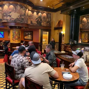 a group of people sitting at a bar