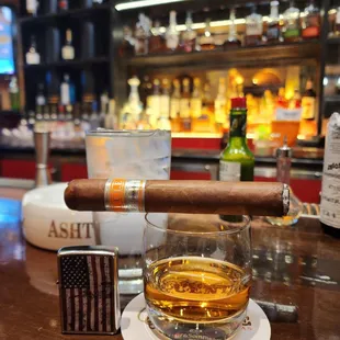 a cigar and a glass of whiskey
