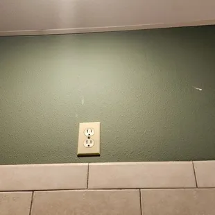 Filthy bathroom with outlet by the ceiling