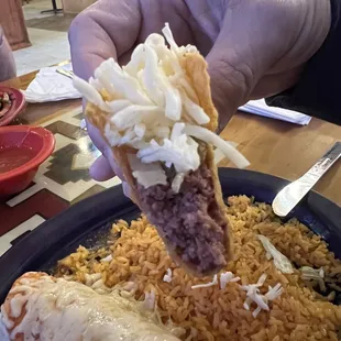 a plate of mexican food with rice and beans