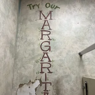 a bathroom with a sign on the wall