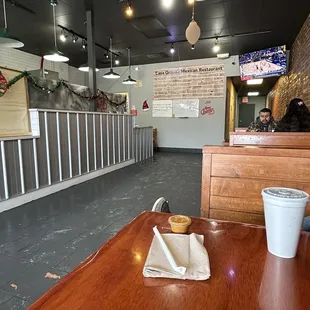 a table with a cup of coffee and a donut on it