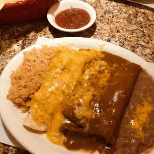 3 item dish: burrito, tamale, enchilada with rice and beans