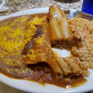 Beef enchilada with pork tamale, rice and beans Good!