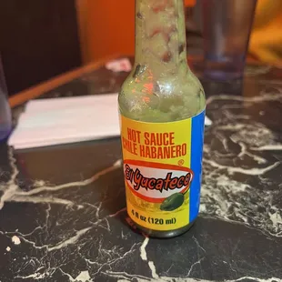 a bottle of hot sauce on a table