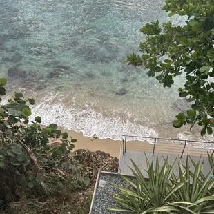 a view of the ocean from the top of a hill