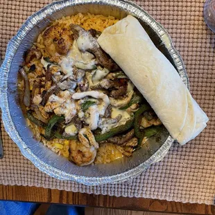 Jalisco Special - shrimp, beef, chicken, peppers and onions over rice covered with cheese sauce excellent!