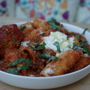 a bowl of pasta and meatballs