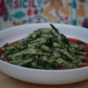 a bowl of pasta with spinach