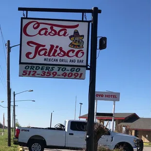 a truck parked in front of a restaurant