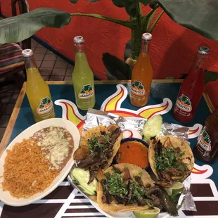 Carbon Tacos! ( fried fresh potatoes, steak, fried onions, cilantro ) Served rice and beans on The side