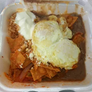 Chilaques rojos, beans, rice, eggs, sour cream, cheese.