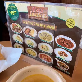 a menu and a bowl of soup