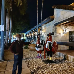 a man standing next to a statue of a pirate