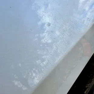 Deep scratches and scuffs all over rear driver-side quarter panel.