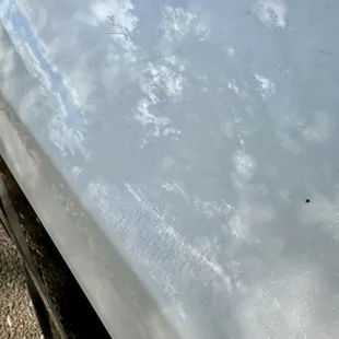 Deep scratches and scuffs all over rear driver-side quarter panel.