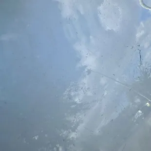 Deep scratches and scuffs all over rear driver-side quarter panel.