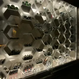 a display of wine bottles in a glass case